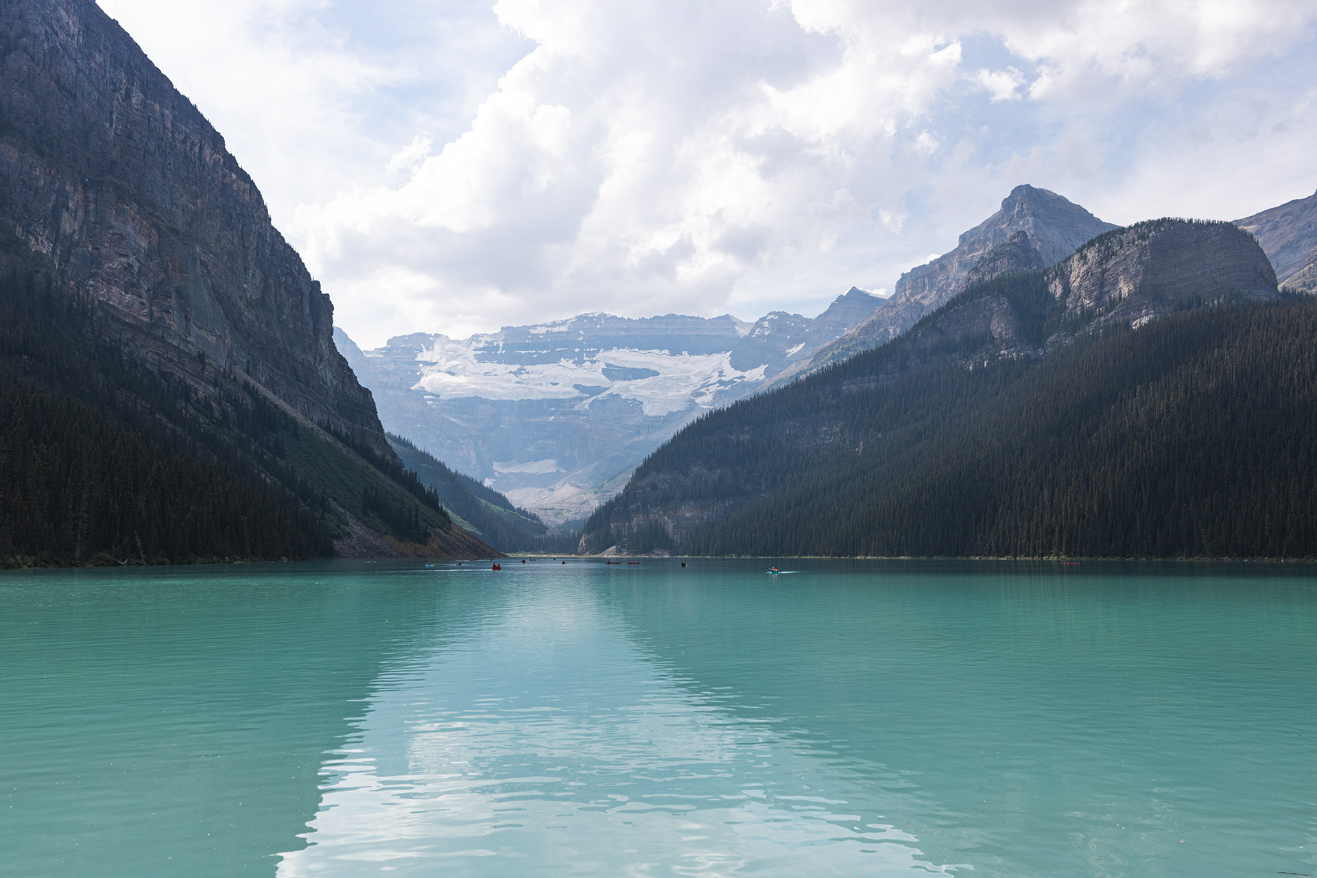 Teal blue lake surrounded by rocky mountains.
